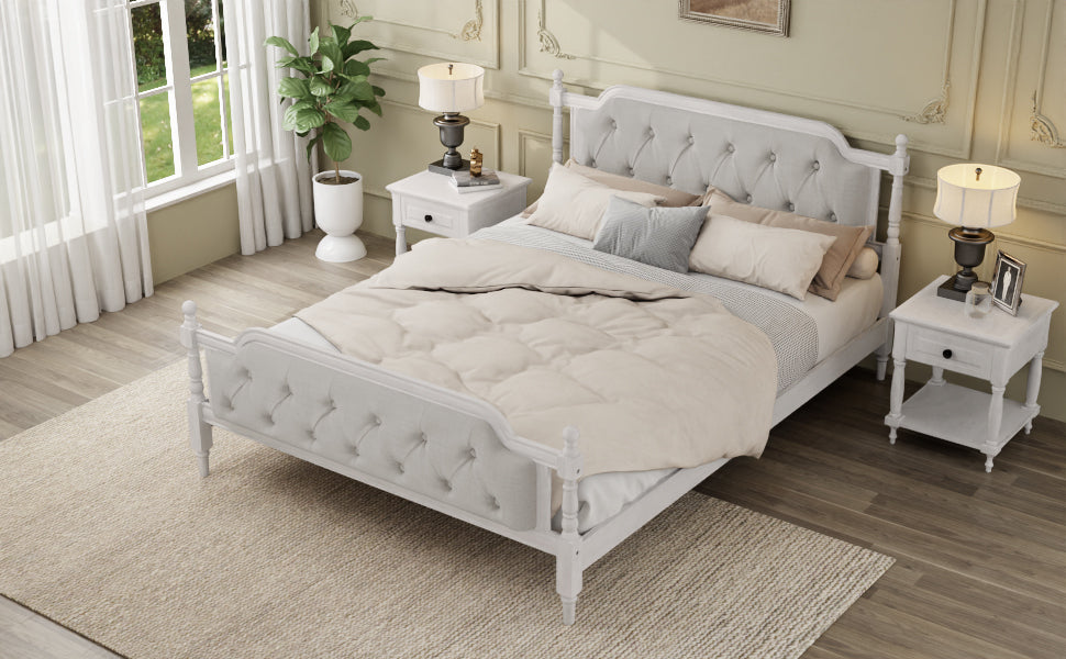 Neatly made bed with gray bedding in a bedroom setting.