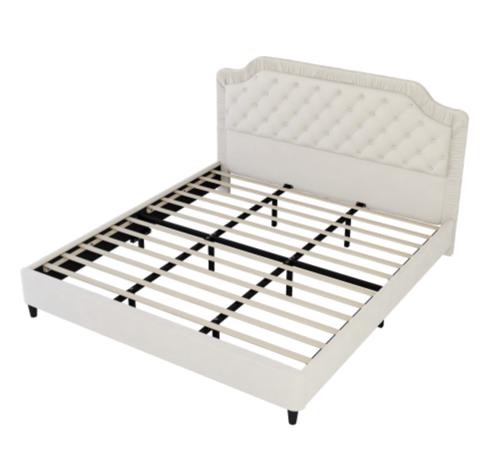 White bed frame with quilted headboard and slats on a white background