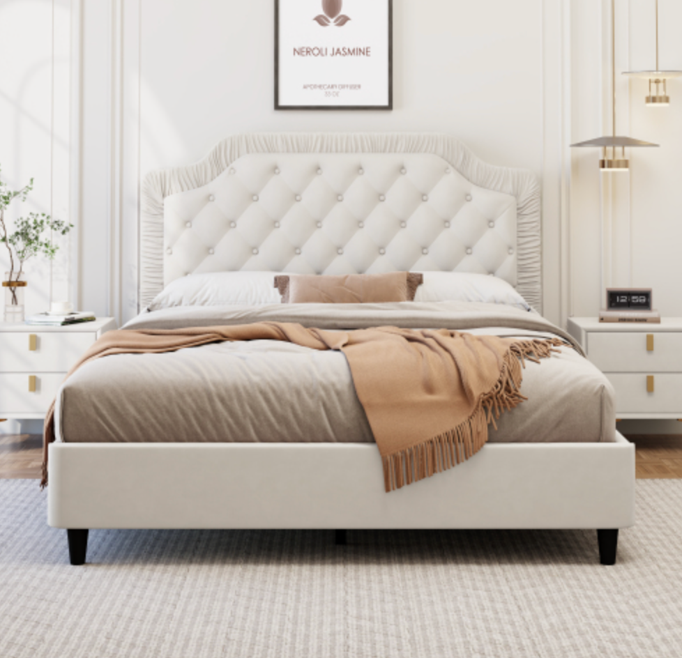 White upholstered bed with tufted headboard in a bedroom setting White Walls