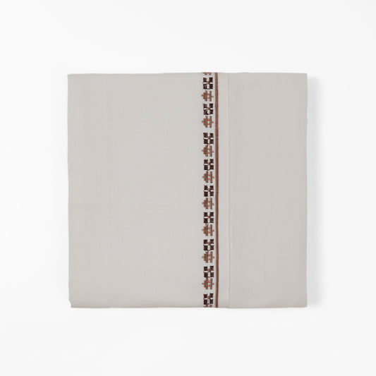 Beige fabric with a decorative brown pattern on a white background