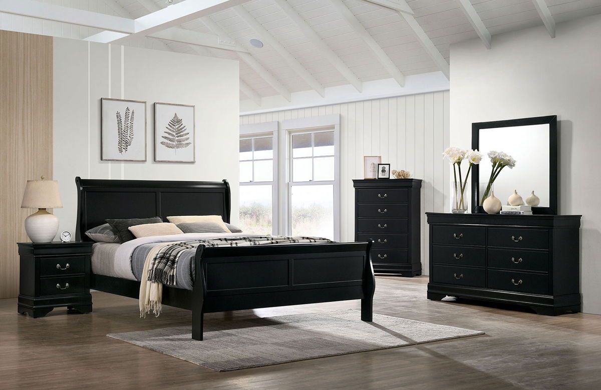 Black bedroom furniture set with bed, dresser, and mirror in a room with large windows.