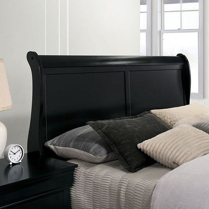Black sleigh bed with pillows and a clock on a nightstand in a bedroom.