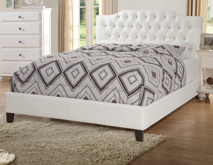 Bedroom with a white upholstered bed and patterned bedding.