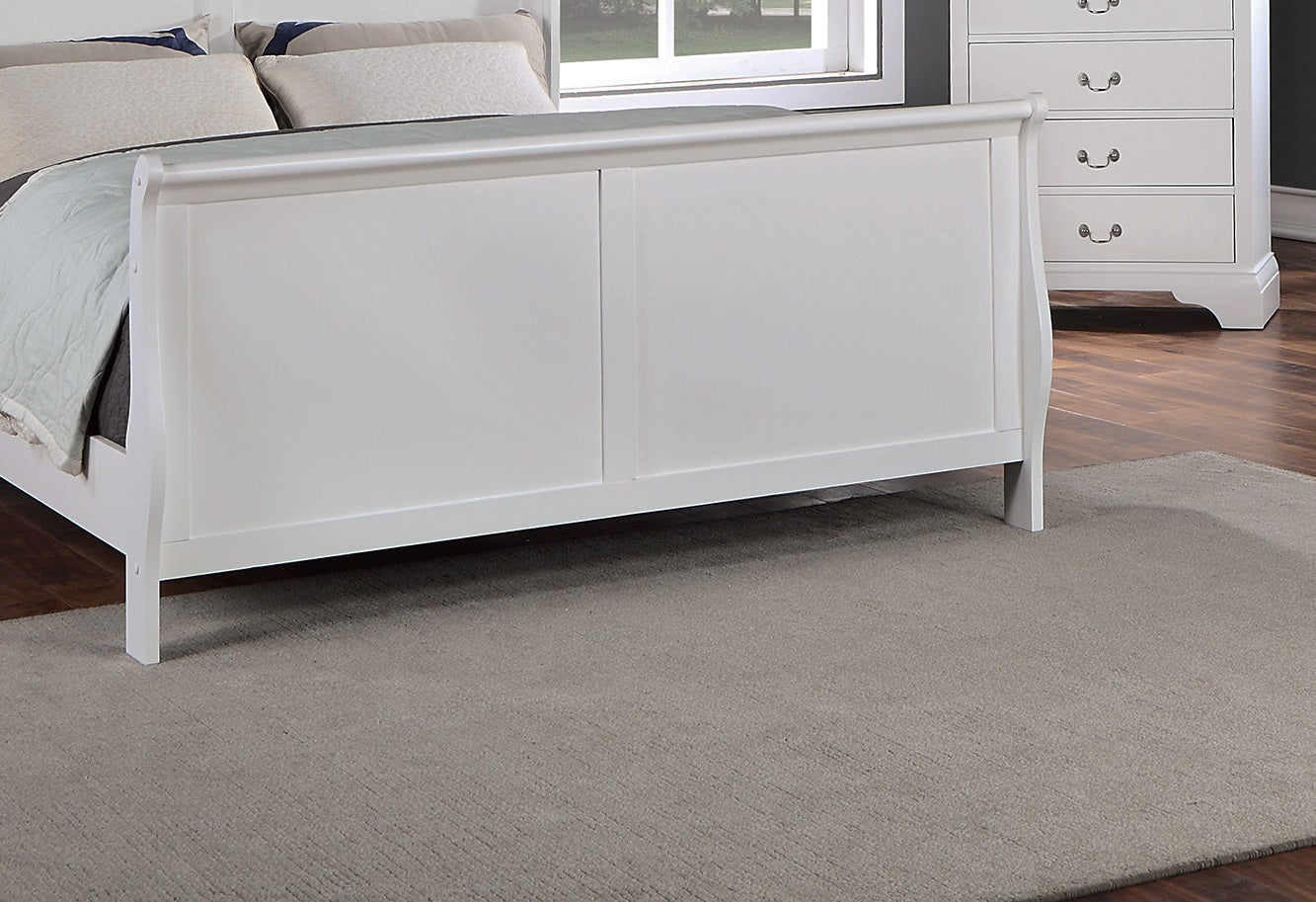 White wooden bed in a bedroom setting with a rug and dresser.