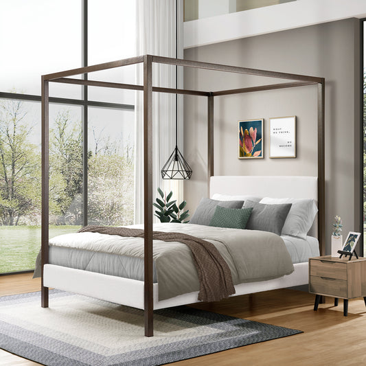 Four-poster bed in a modern bedroom with large windows and decor.