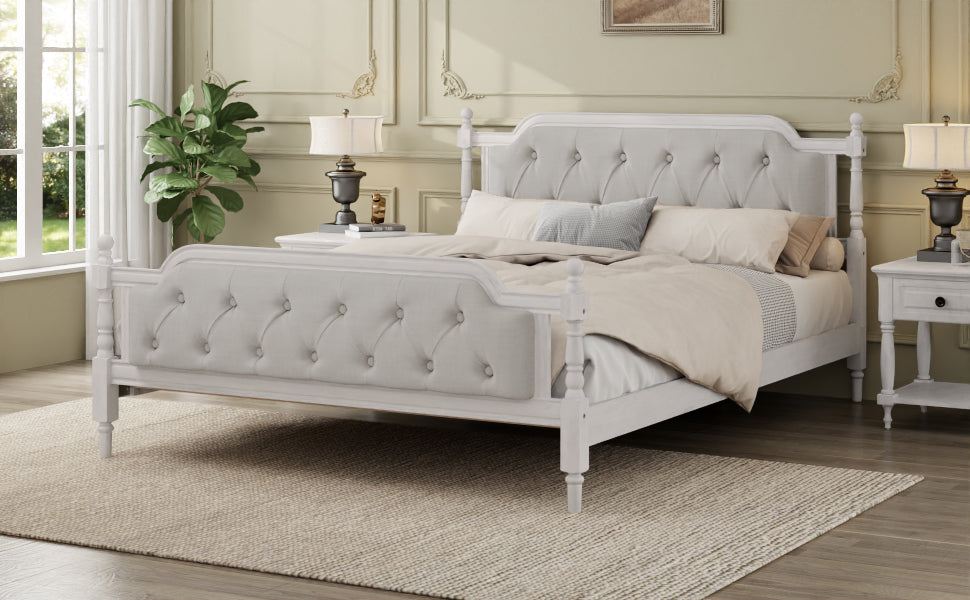 Gray upholstered bed in a bedroom setting with decor elements.