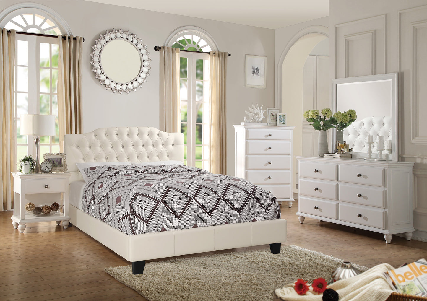 White bedroom set with bed, dresser, and mirror in a well-lit room.