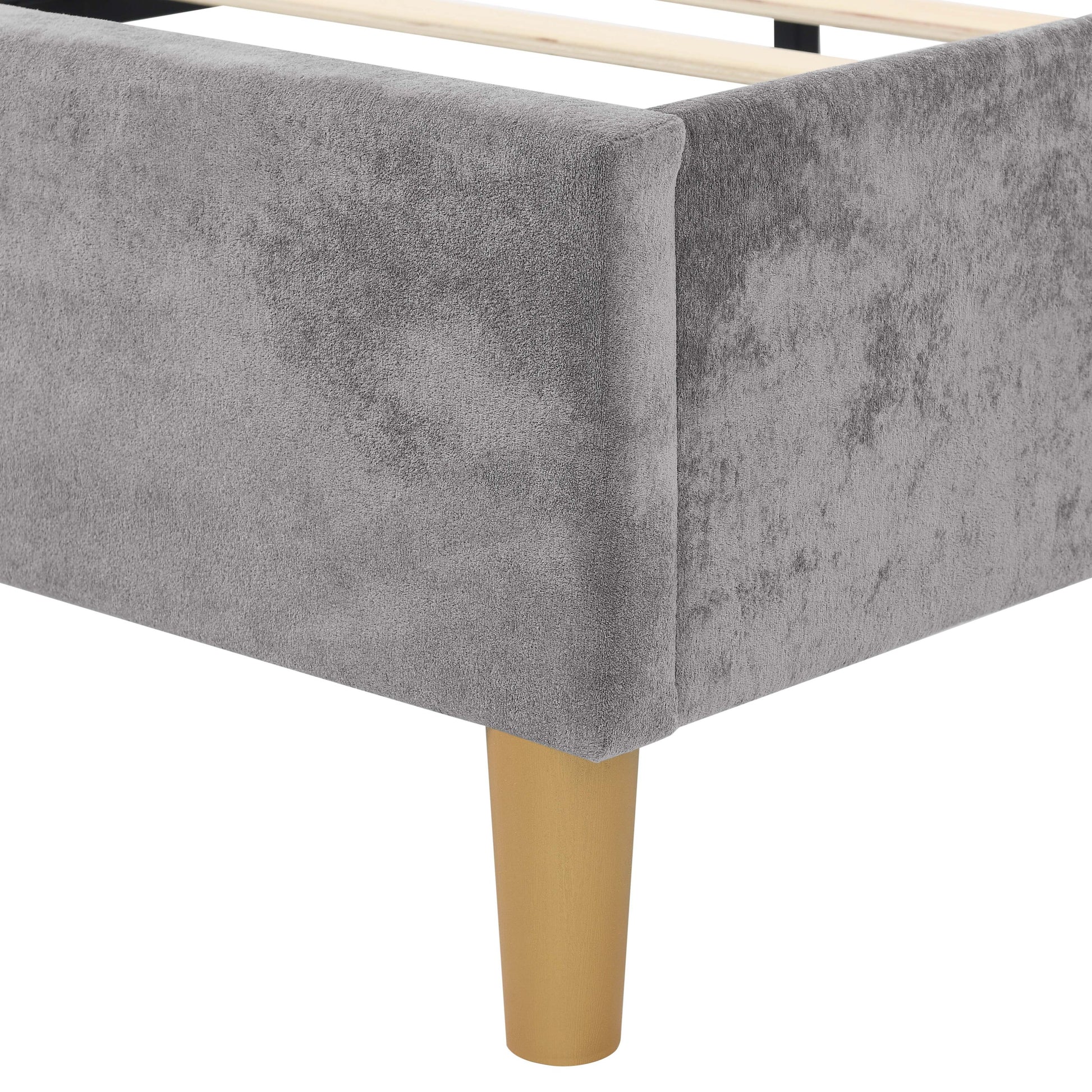 Gray bed skirt with a yellow bed frame leg on a white background