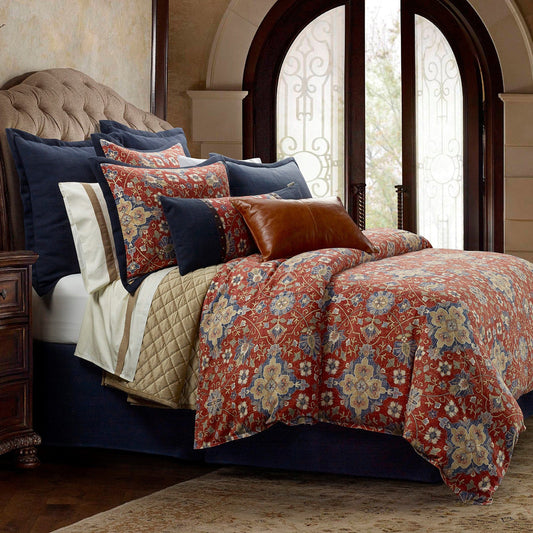 Decorative bed with floral comforter and pillows in a bedroom setting