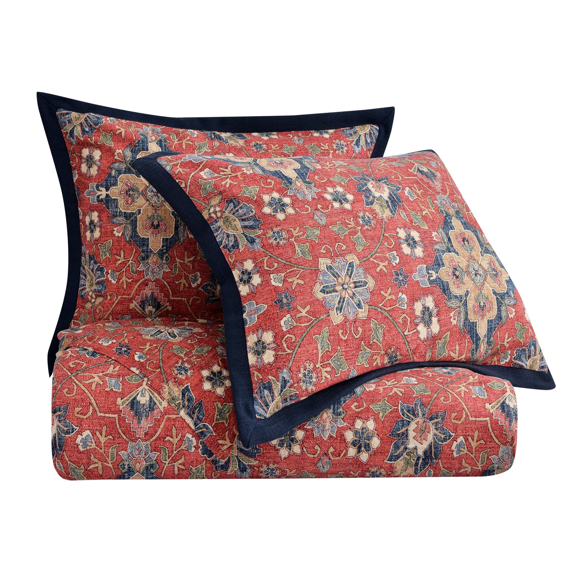 Floral patterned quilt with matching pillow on a white background