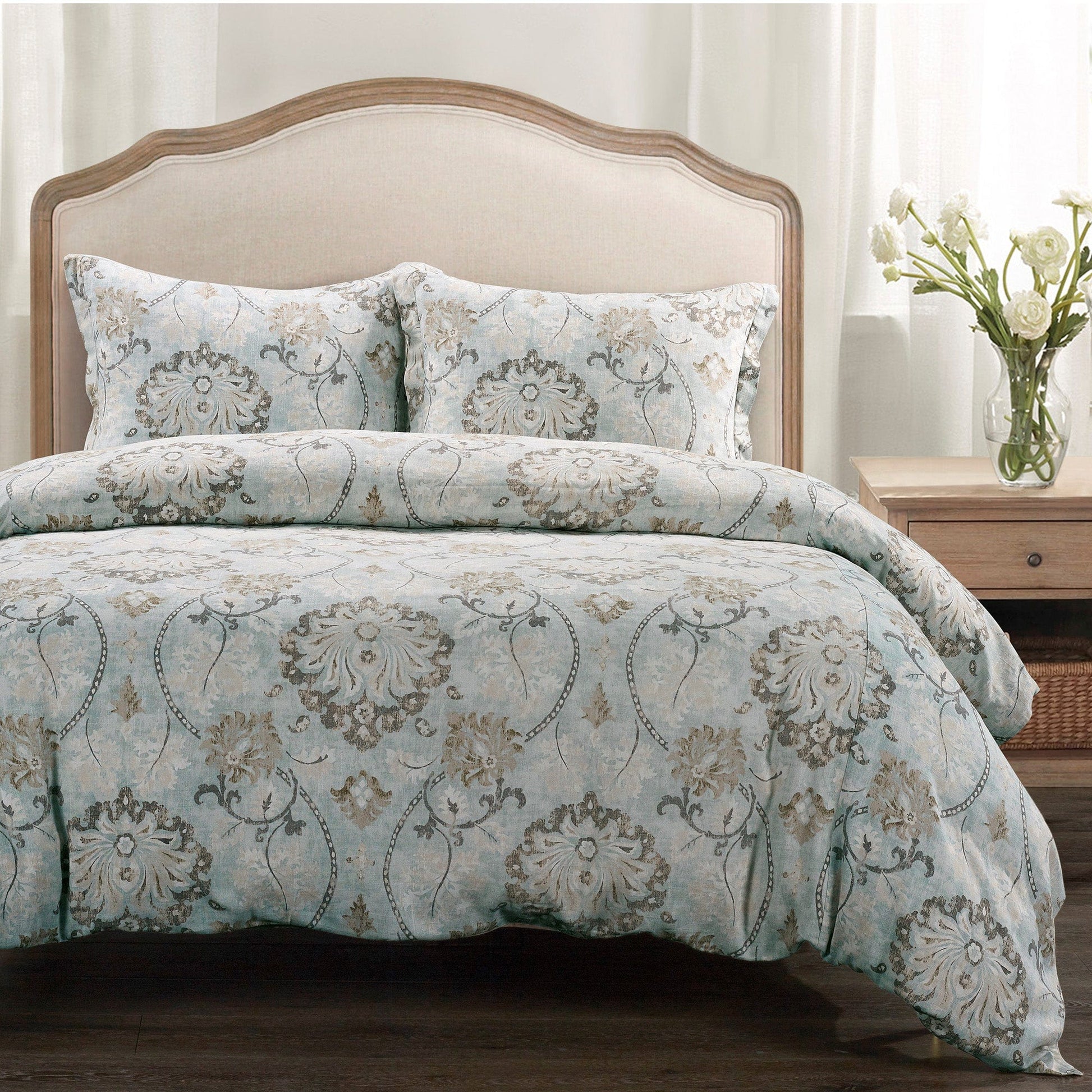 Bed with floral patterned bedding in a bedroom setting