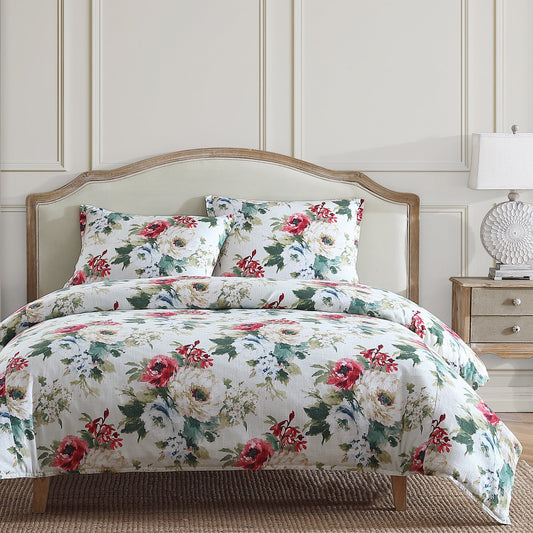Floral bedding set on a bed with a matching headboard and nightstand.