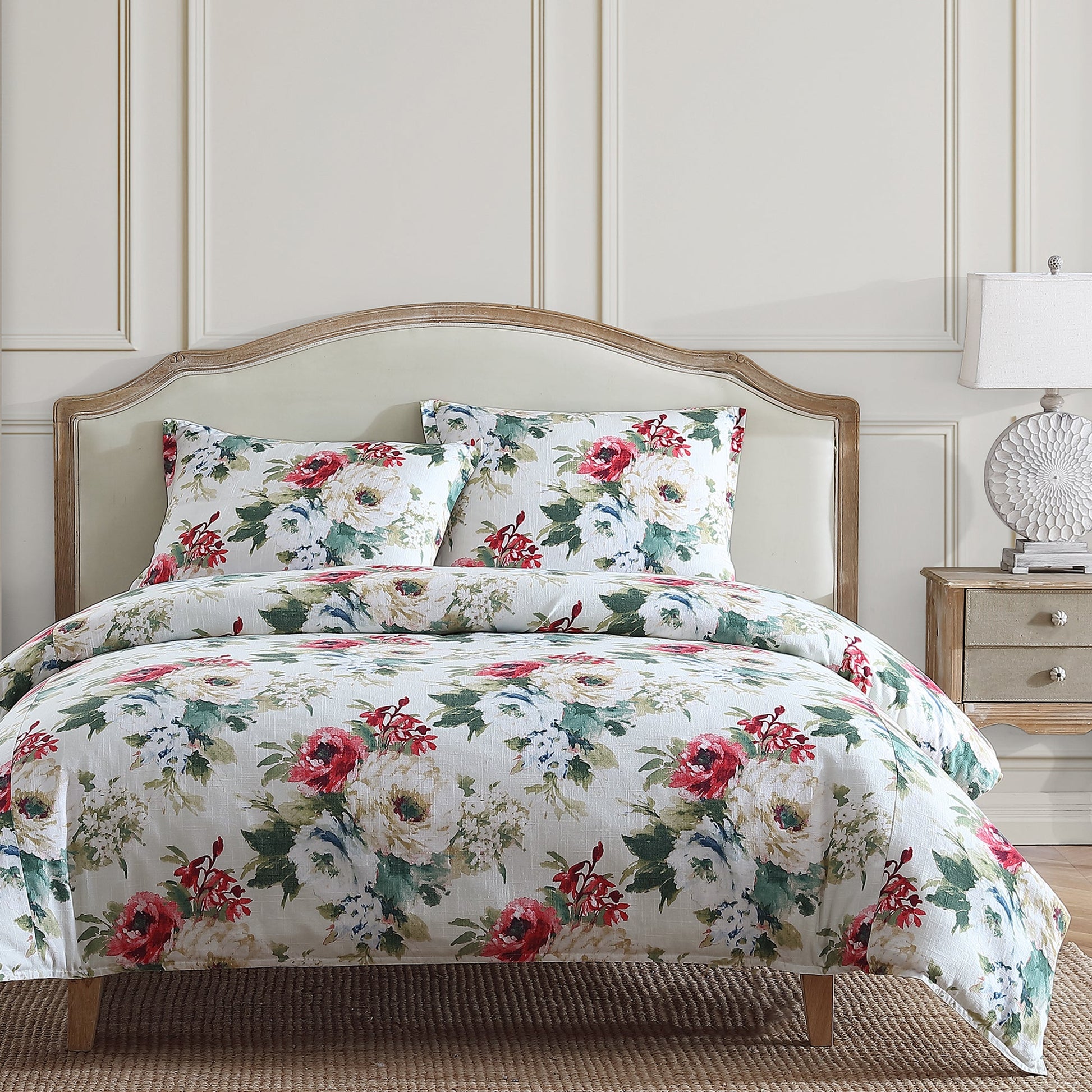 Floral bedding set on a bed with a matching headboard and nightstand.