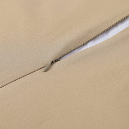 Close-up of a beige fabric with a zipper running along the edge.