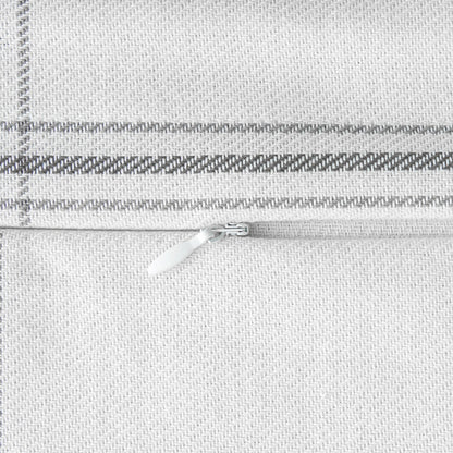 Close-up of a silver zipper on a textured gray fabric background