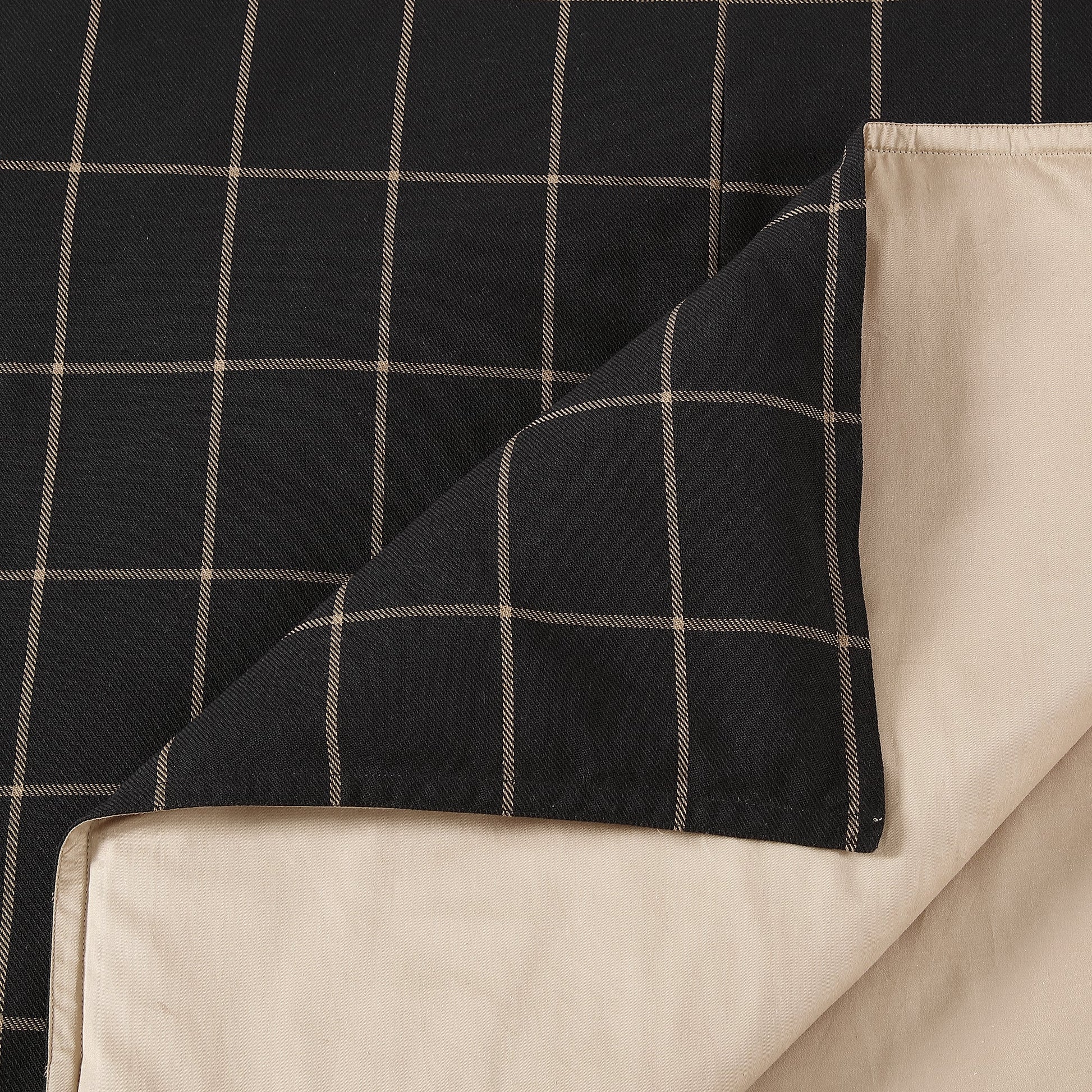 Black checkered fabric draped over a beige surface