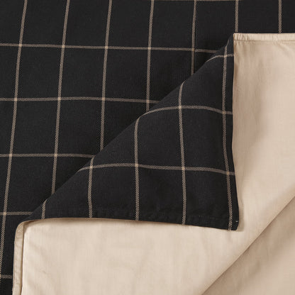 Black checkered fabric draped over a beige surface