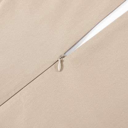Close-up of a white zipper on beige fabric