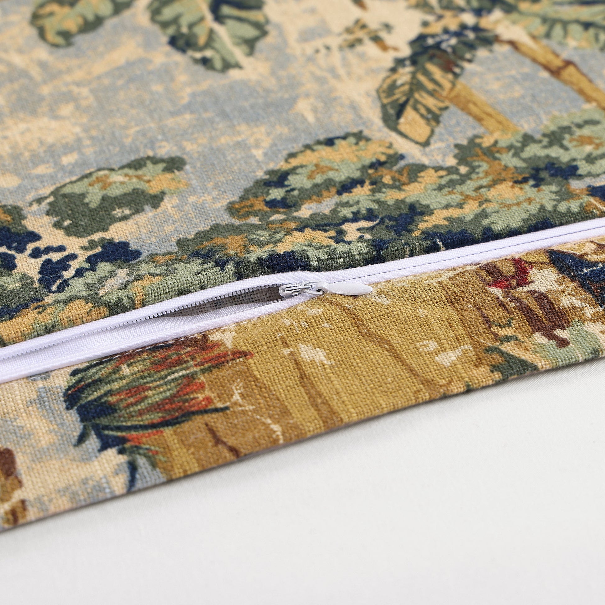 Close-up of a fabric pouch with a detailed pattern and zipper on a white background