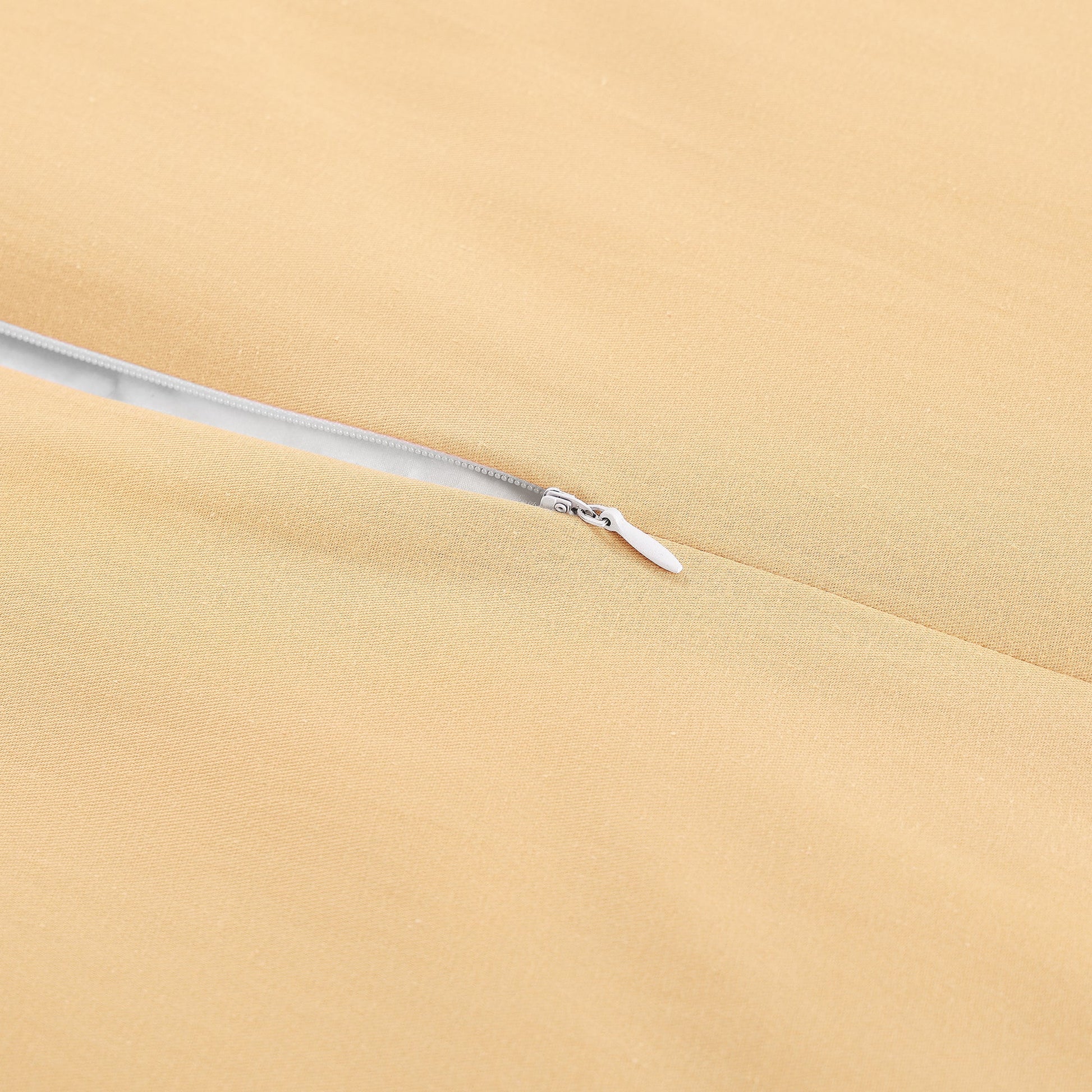Close-up of a zipper on beige fabric