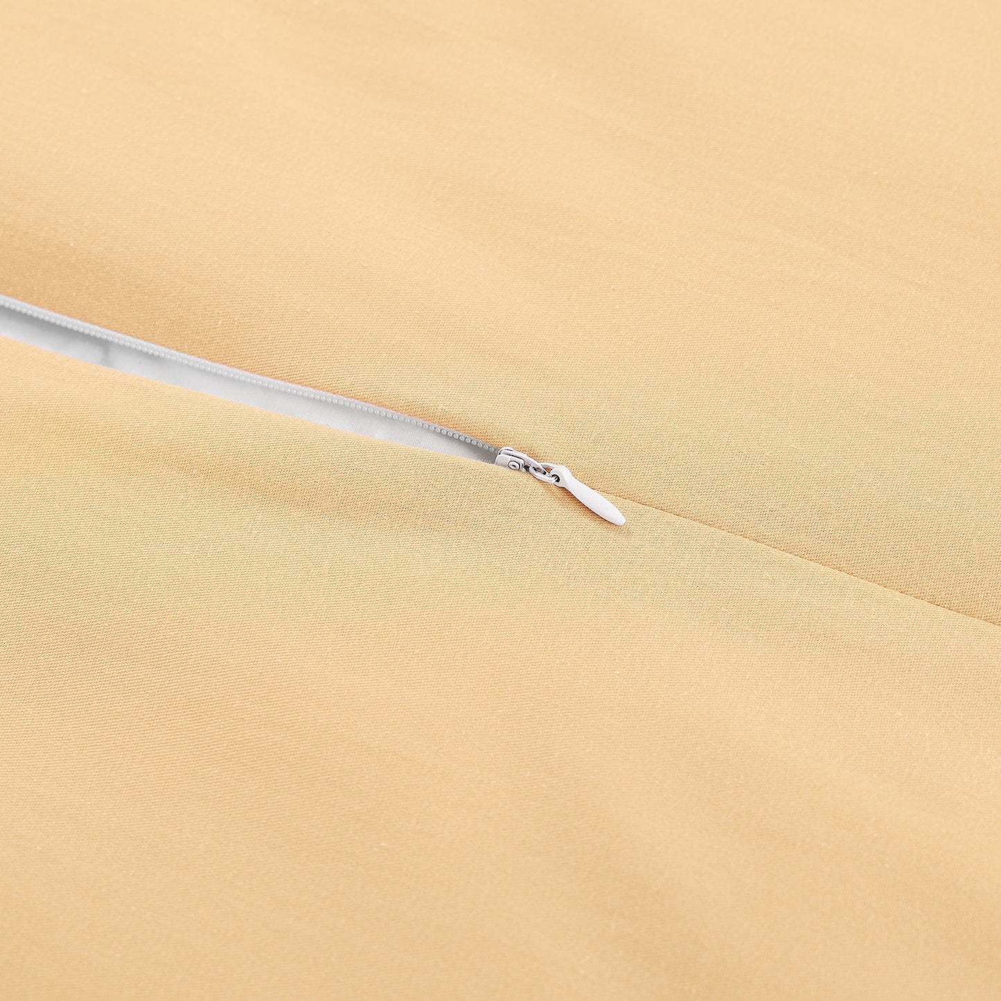 Close-up of a zipper on beige fabric