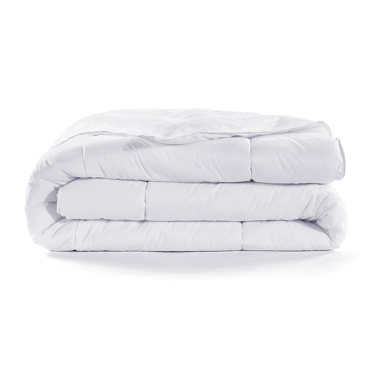 Stack of white comforters on a white background