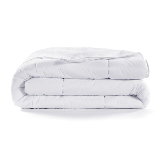 Stack of white comforters on a white background