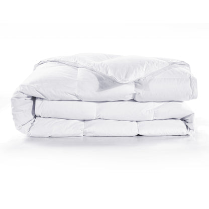 Folded white comforter on a white background