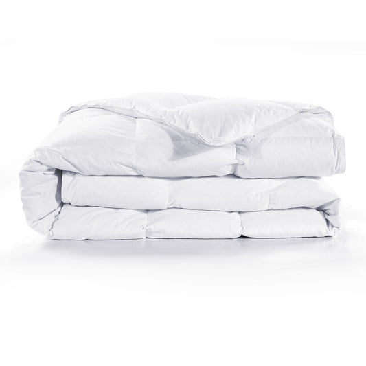 Folded white comforter on a white background