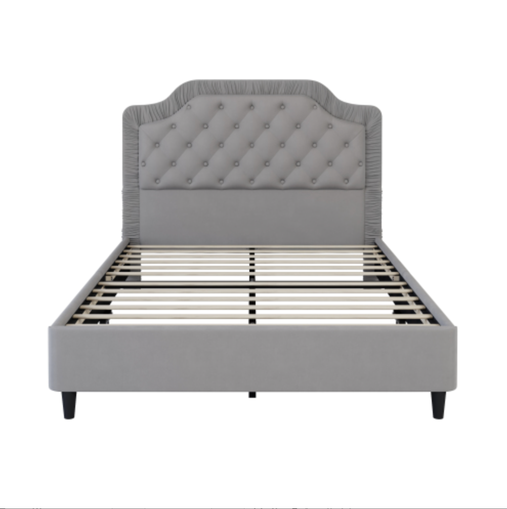 Gray upholstered bed with tufted headboard and bed slats on a white background