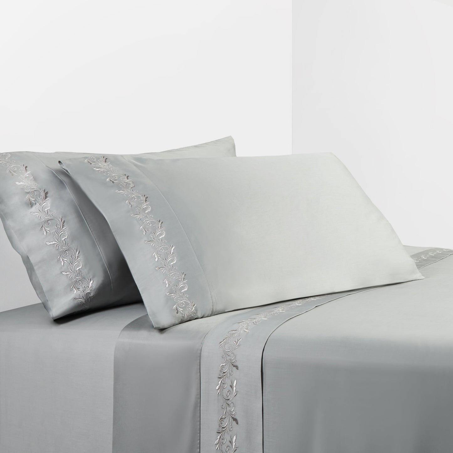 Gray bed sheet set with floral embroidery on a white background