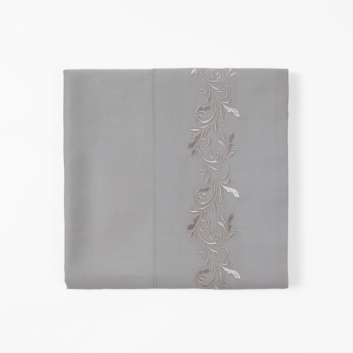 Gray pillowcase with floral embroidery on a white background