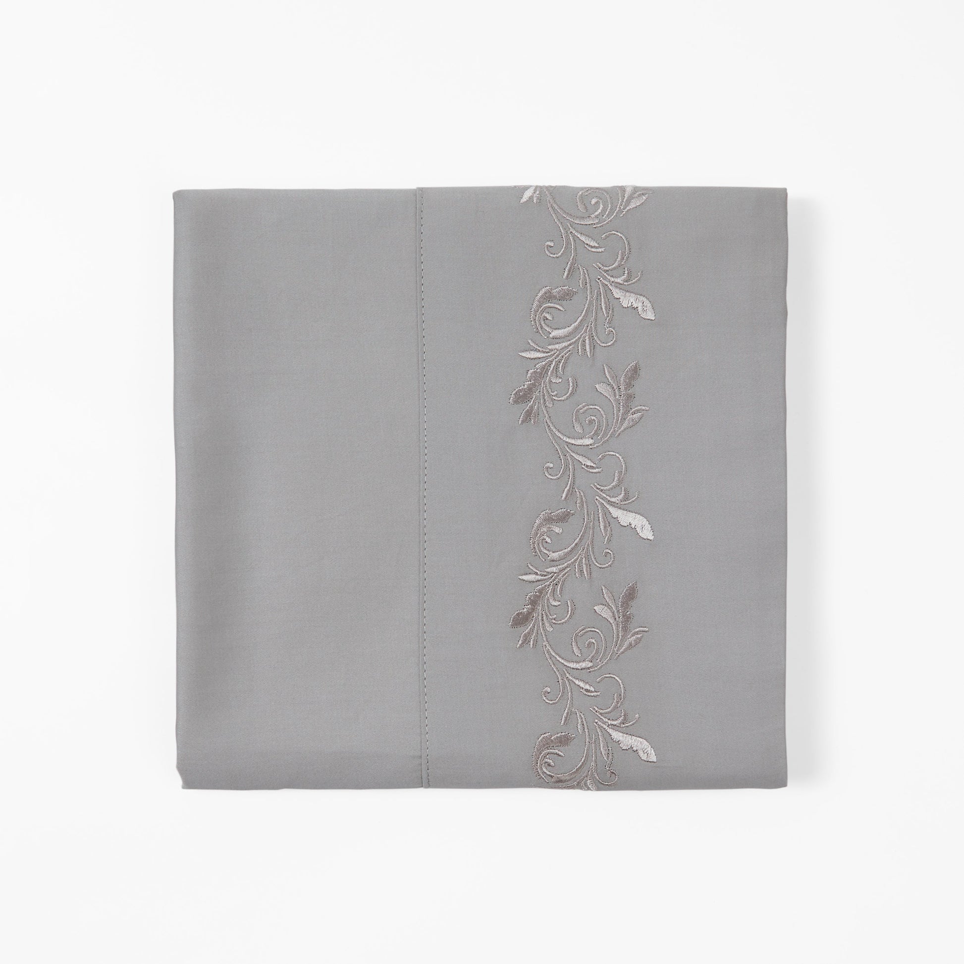 Gray pillowcase with floral embroidery on a white background