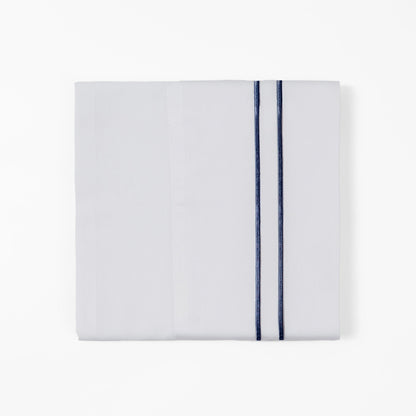 Folded white towel with a blue stripe on a white background