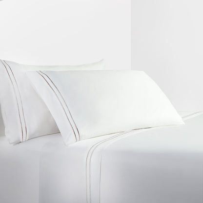 White bed sheets and pillowcases on a white background