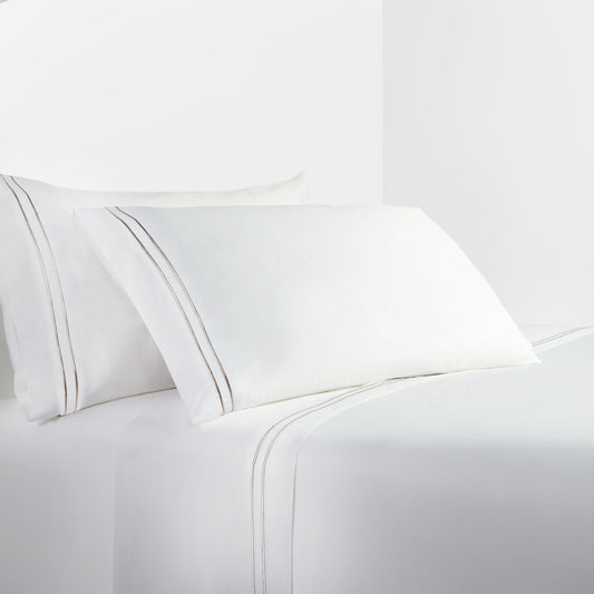 White bed sheets and pillowcases on a white background