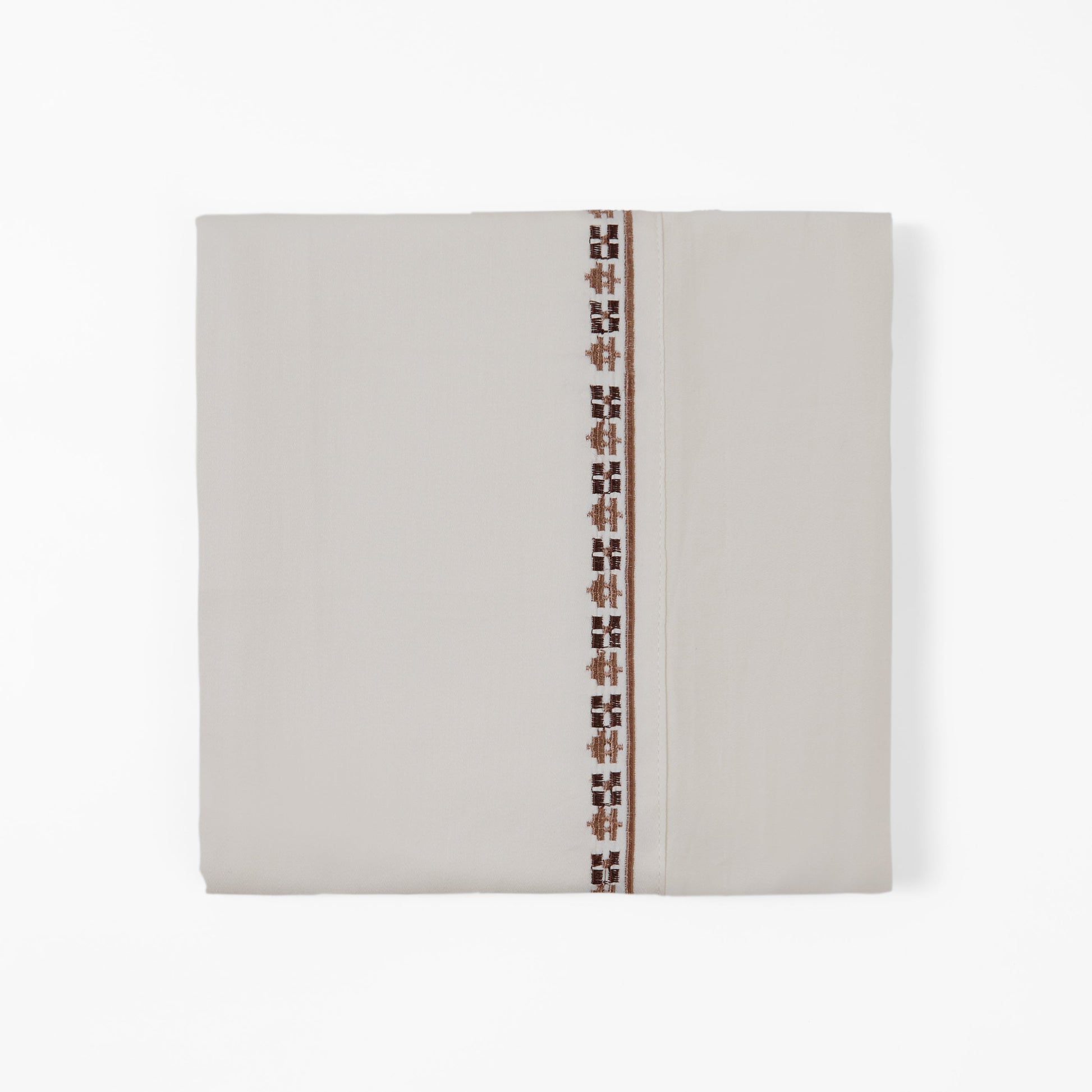 Beige fabric with a decorative brown pattern on a white background
