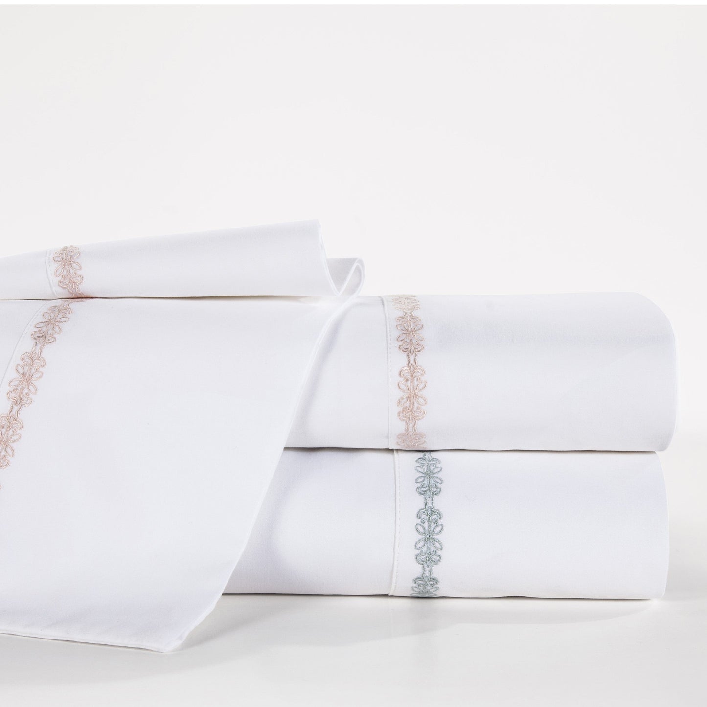 White pillowcases with decorative embroidery on a white background
