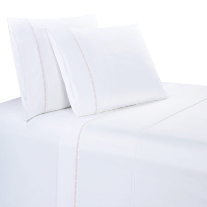 White bed sheets and pillows with a subtle stripe on a white background