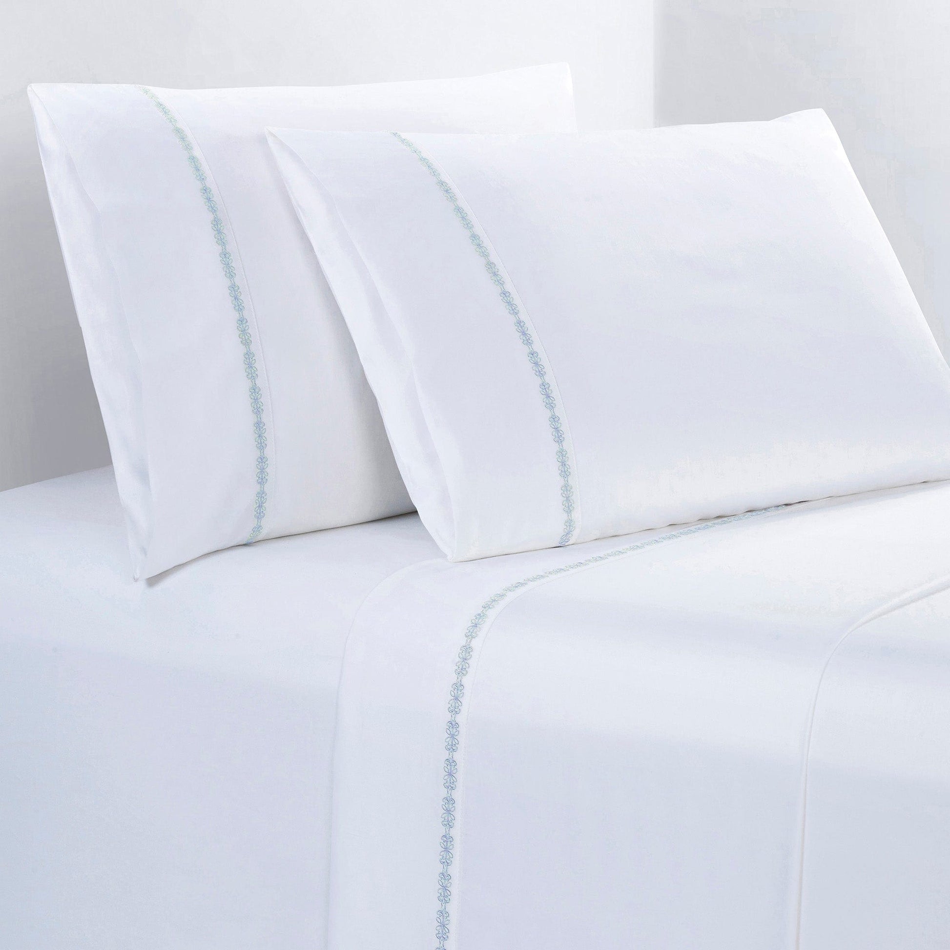White bed sheets with subtle blue stripes on a white background