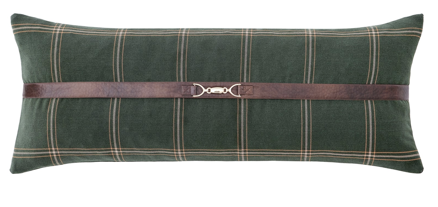 Green plaid pillow with a brown leather strap on a white background