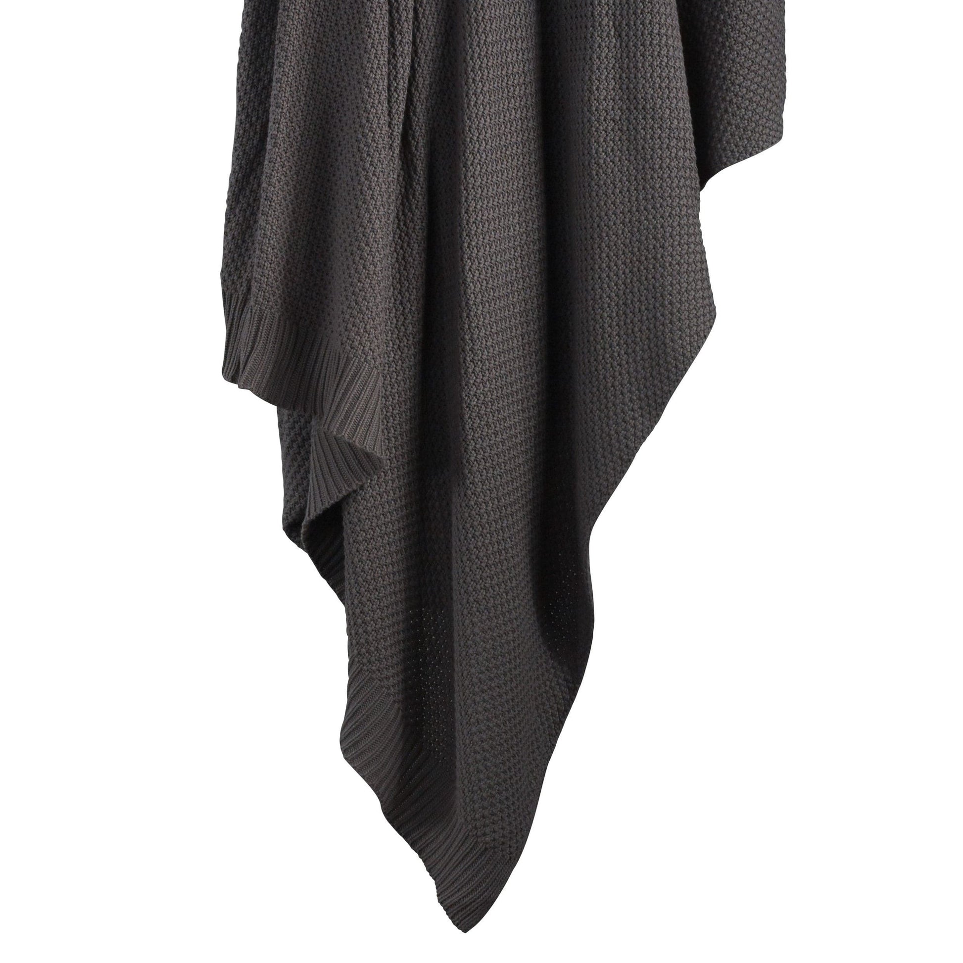 Dark gray textured blanket draped over a white background