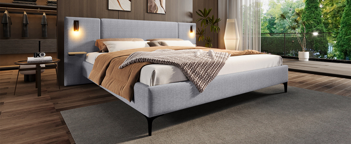 Modern bedroom with a gray upholstered bed, wooden floor, and decorative elements.