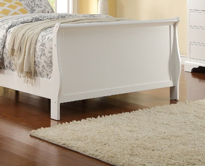 White sleigh bed with floral bedding and a beige throw in a bedroom setting.