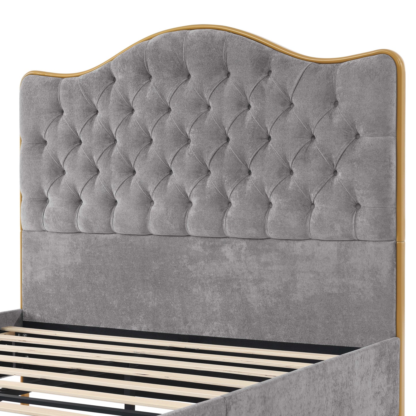 Gray tufted headboard with gold trim on a bed frame.
